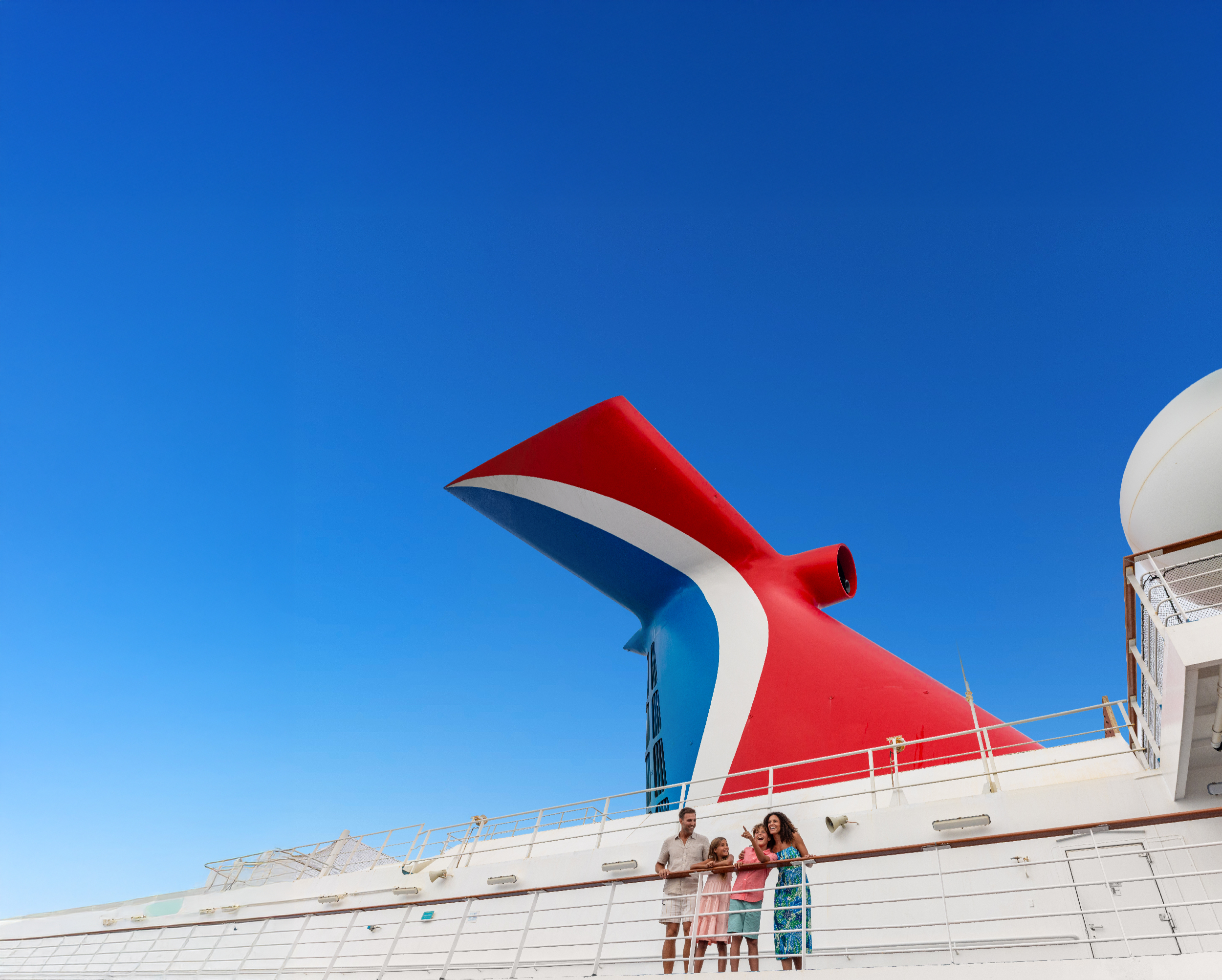 Family on deck below the Carnival funnel